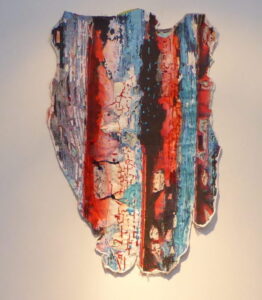 A triptych of layered embroidered appliqued art representing peeling paint.