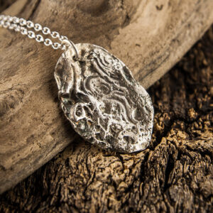Silver pendant molded on a pebble