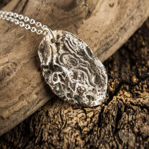 Silver pendant molded on a pebble